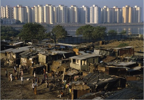 contrast between shacks in the foreground and tower blocks on the skyline